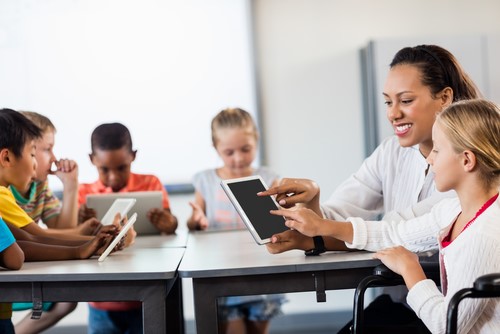 Students Using Tablet PCs in Class with Teacher